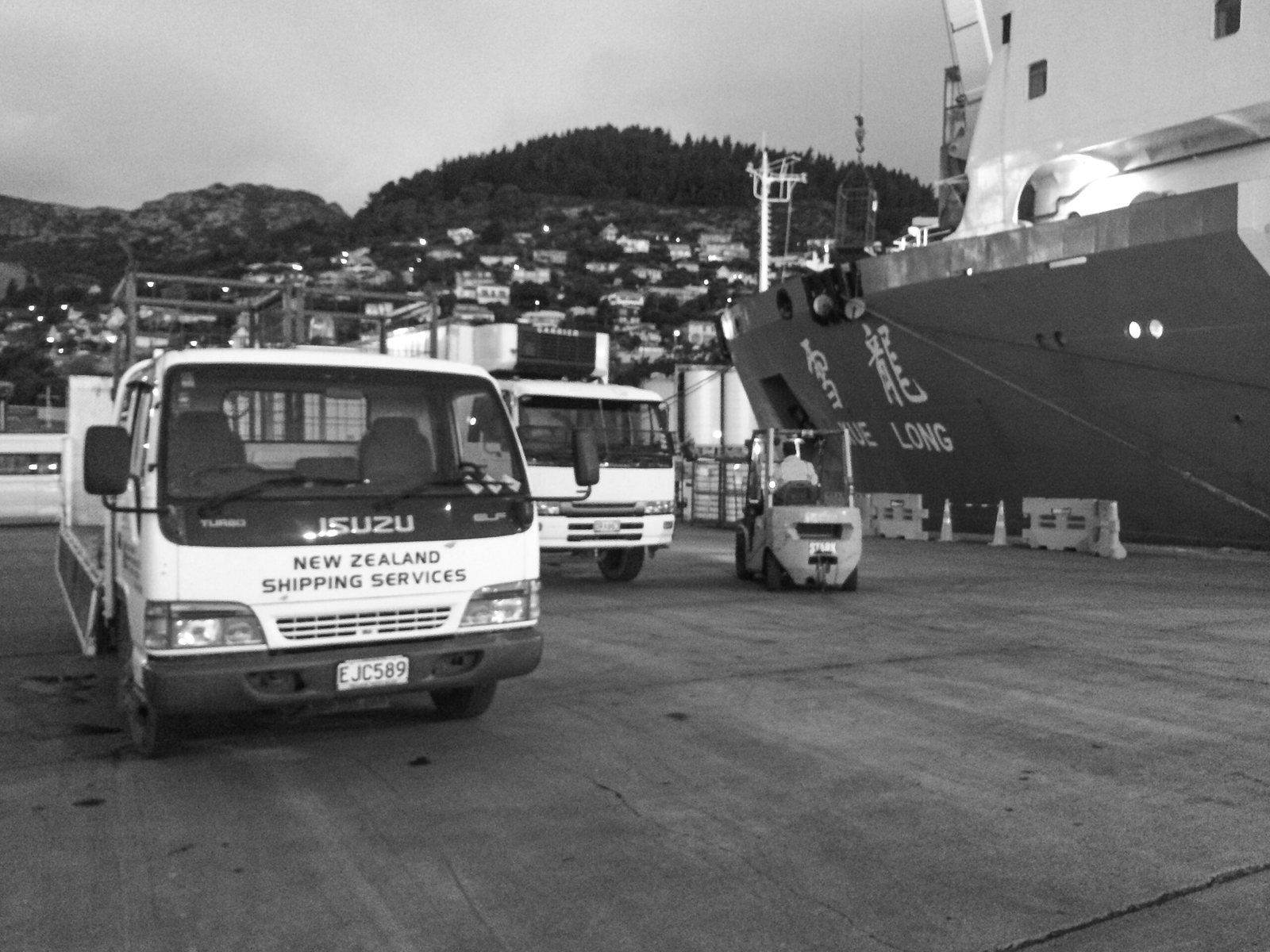 NZ Ship Supplies delivery truck on the wharf, loading provisions for a cargo vessel